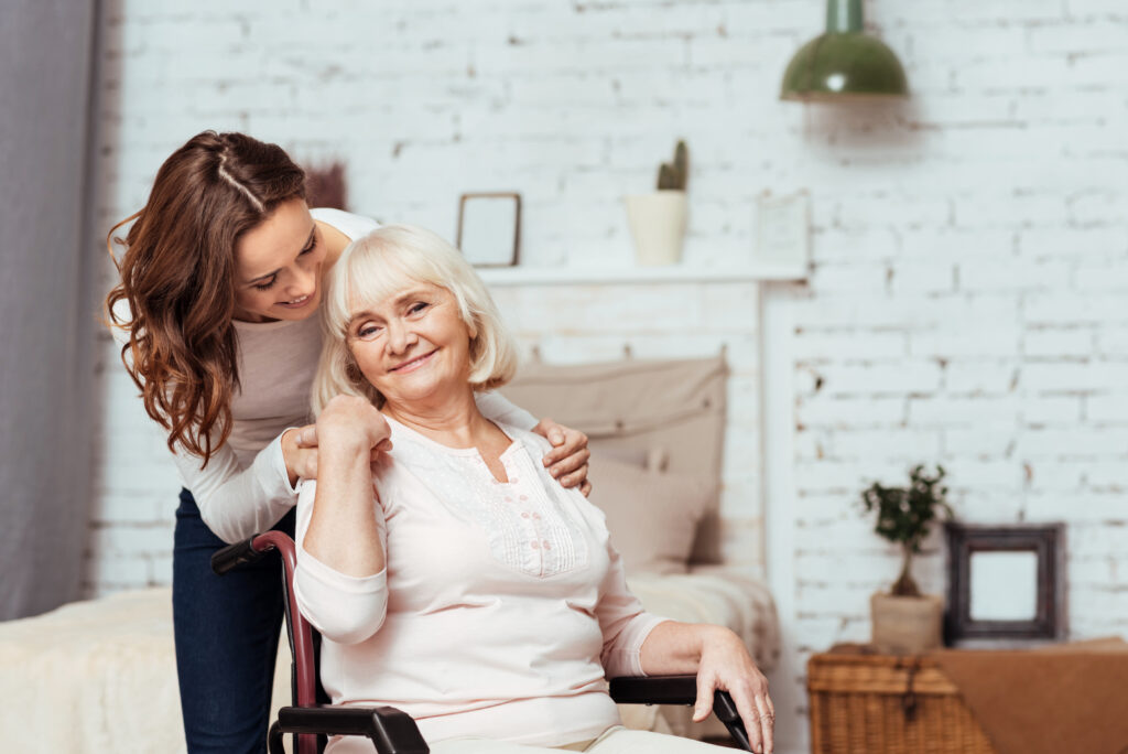 Cheerful elderly woman sittig in the wheelchair