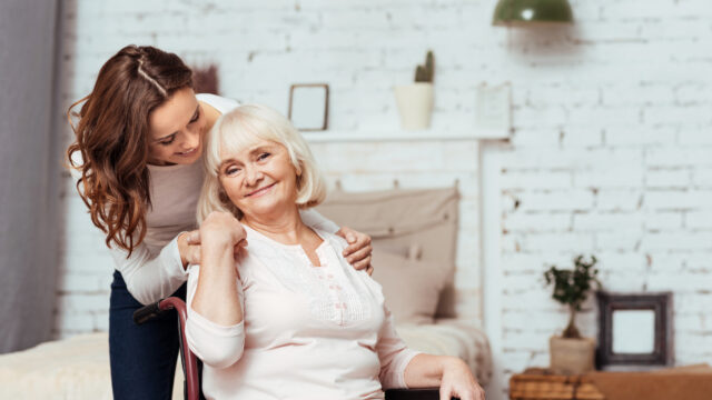 Cheerful elderly woman sittig in the wheelchair