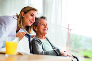 Health visitor and a senior woman during home visit.